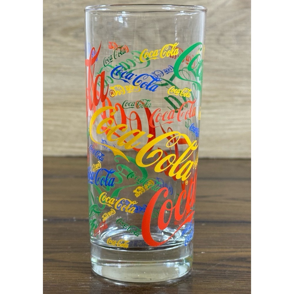 COCA COLA Tall glass with multi-color writing all over 14 oz‎
